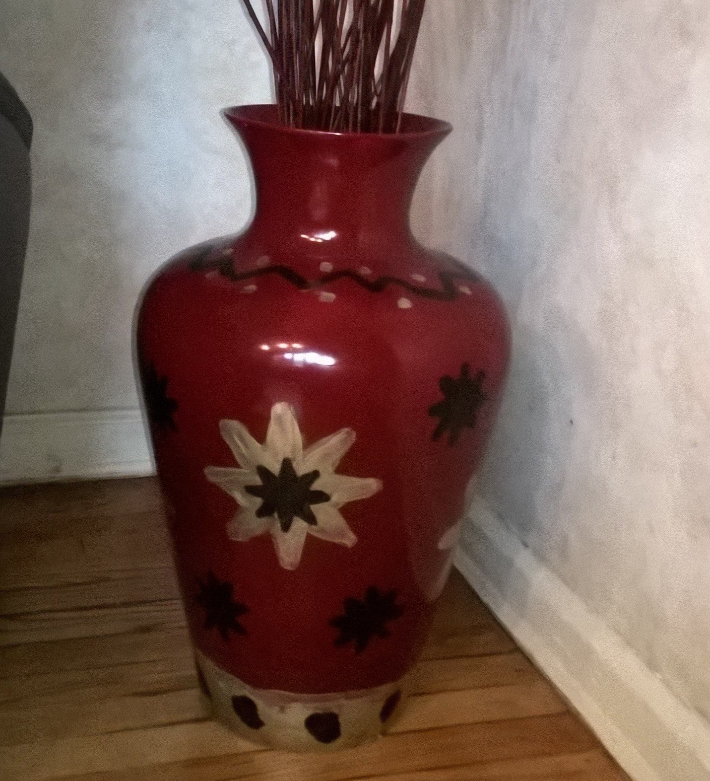 maroon vase with decorative stenciling