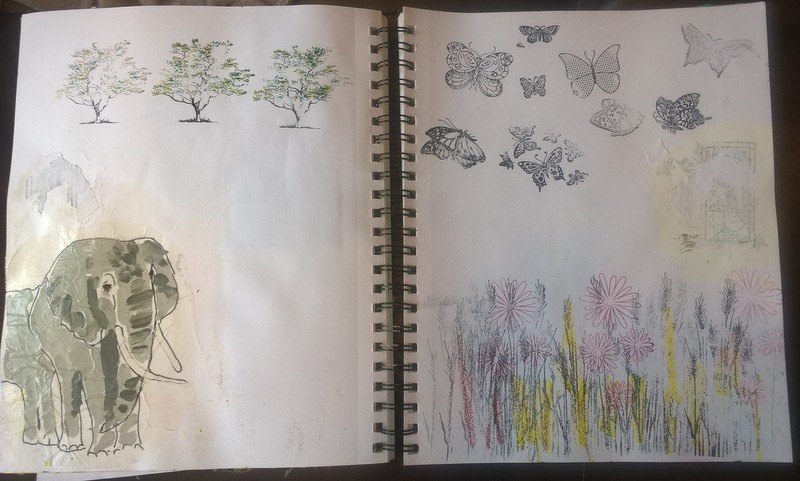 journal spread with traced elephant and nature stamps