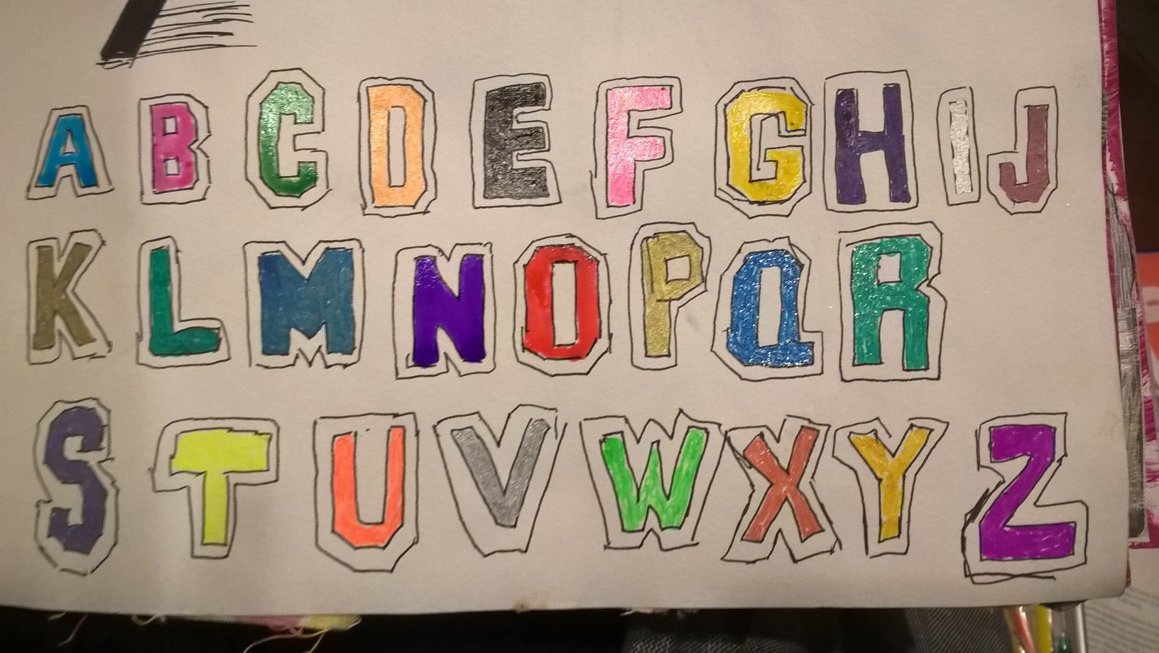 alphabet written with gel and glaze pens