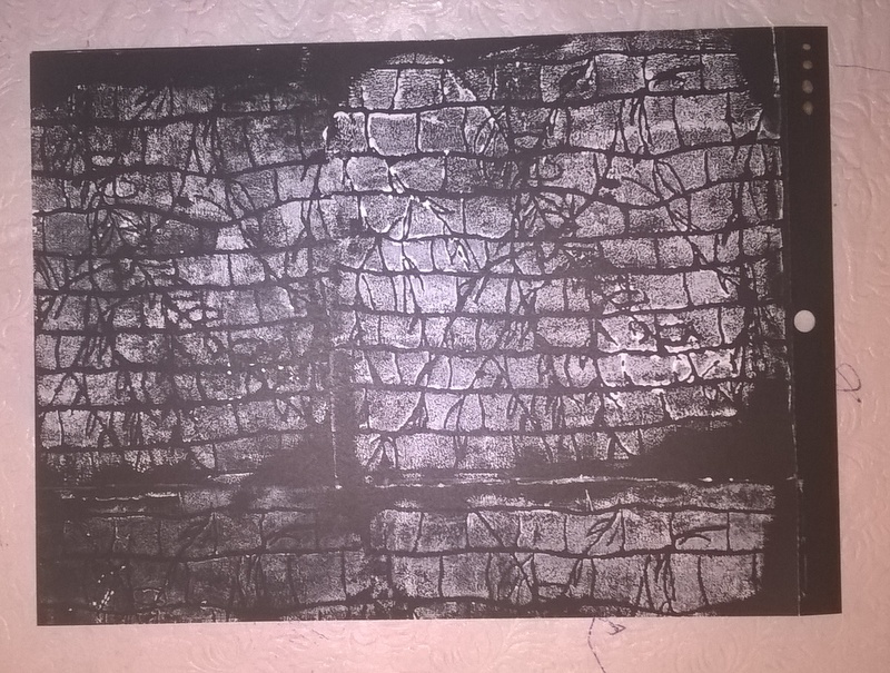 stamped Styrofoam tray with white paint on black paper