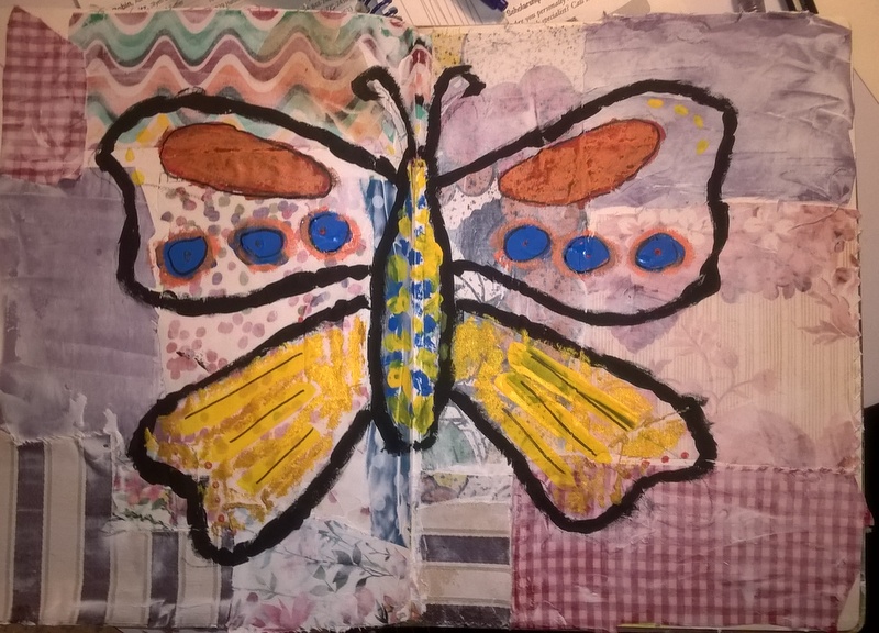 mixed media art with fabric background and butterfly painted on top