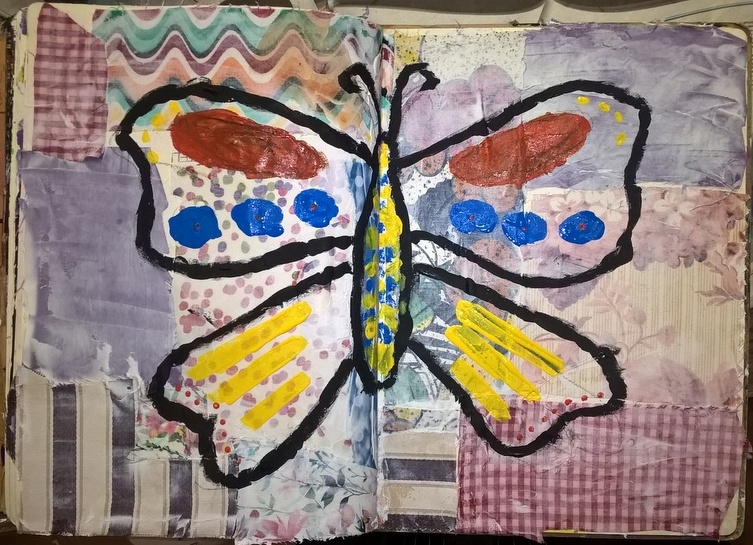 mixed media art with fabric background and butterfly painted on top