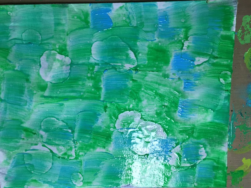 blue and green acrylic painted on background with alcohol dripped on