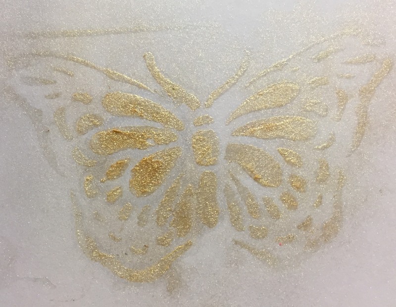 gold pigment powder through  butterfly stencil