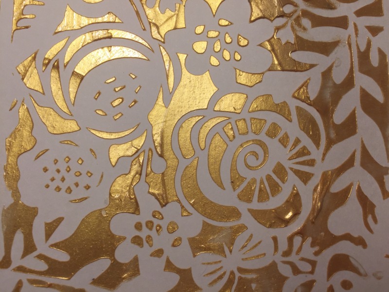 close up view of dried medium and pearl ex powder through a  stencil